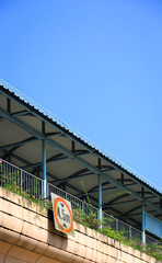 overhead pedestrian walk bridge in blue sky background