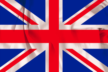 beautiful national flag of Great Britain on soft silk with soft folds, close-up, copy space