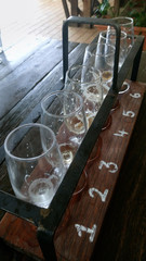 Fototapeta na wymiar Empty glasses with different sorts of craft beer on wooden bar.