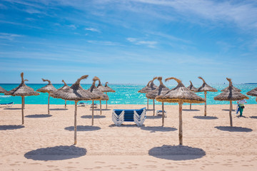 Beach chairs isolated on paradisiacal beach on a sunny day