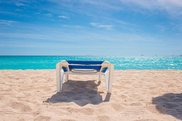 Beach chair isolated on paradisiacal beach on a sunny day