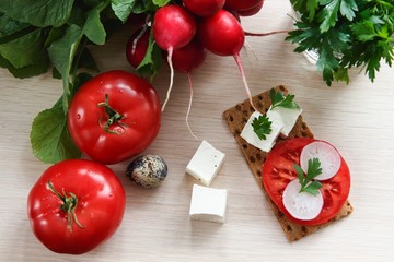 Fresh vegetables and white cheese on wooden background