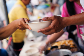 Beggar begs food from donors : The Concept of Donating Food to the Poor in Society
