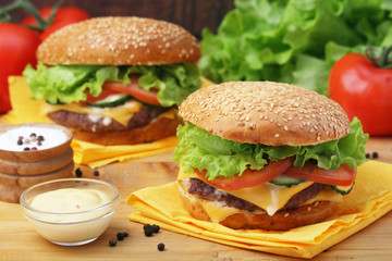 Two fresh hamburgers with vegetables