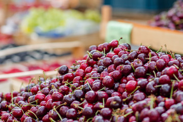 Cherries basket at the Bio market. Closeup Red fruits Bilder