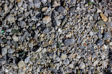 Stone rock background texture, gray stone road. Rubble, macadam background texture close up. Natural environmental background texture. 