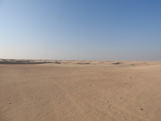 Fototapeta na wymiar Dunes in the sahara, merzouga morocco. Golden desert dunes. Hills of the sahara. Evening in the desert. Lanscape morocco. Scenic view.