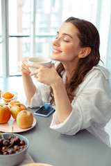 Woman thinking about the day drinking coffee in the morning