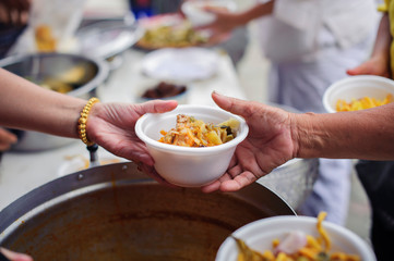 Hands of beggars accepting food from the hands of volunteers who come to help free food breaks : Social Problems of Poverty Helped by Feeding