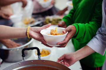 concepts of poverty in Asian society : Volunteers Share Food to the Poor to Relieve Hunger