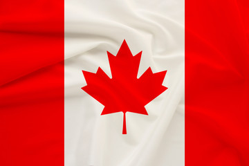 Canada national flag on gentle silk with wind folds, travel concept, immigration, politics