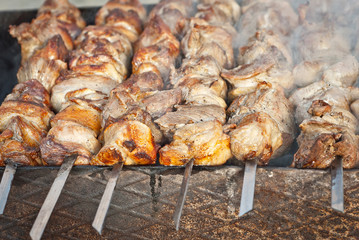 Barbecue fries in the coals. Meat and beef at the field kitchen festival.