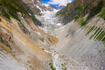 Caucasus Mountains on the border of Russia and Georgia. Chalaat Pass and Very beautiful view of the Chalaadi Glacier, Mount Ushba and Mestiachala river with background of clear blue sky.
