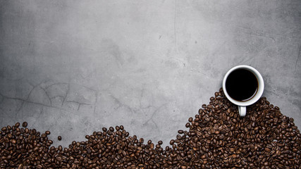 cup of coffee and beans on concrete background