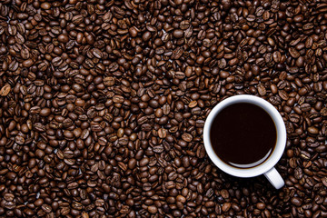 cup of coffee on coffee beans background