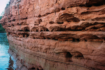 Red natural sand stone on Tosna river near Sablino