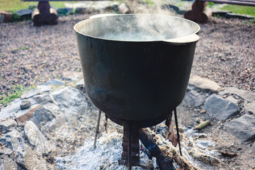 Cooking on a fire in a cauldron in the camp