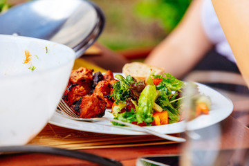 Plate with meat and salad at a grill party