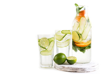 Natural lemonade with orange,lime, cucumber and mint in bottle isolated on white background. Detox water for a healthy lifestyle.