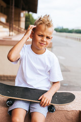 Boy skater posing with skateboard © Виктория Карлова