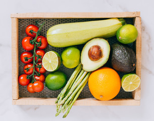 Top view fresh other healthy vegetables in wooden box on white marble background