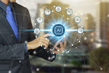 Businessman use tablet with virtual screen Artificial Intelligence technology icon over the Network connection, Artificial Intelligence Technology Concept.