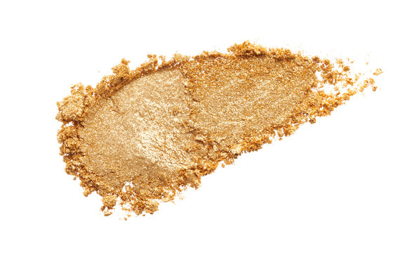 Texture of gold eye shadow isolated on white background. Macro texture of broken gold powder