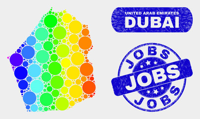 Spectrum dot Dubai Emirate map and watermarks. Blue rounded Jobs scratched stamp. Gradiented spectrum Dubai Emirate map mosaic of randomized circle. Jobs stamp with scratched texture.