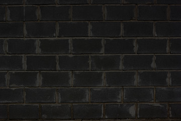 Texture of black brick wall background. Retro abstract closeup of grunge texture dark gray brick wall. Black stone dilapidated background. Dark grey shabby blank space architecture