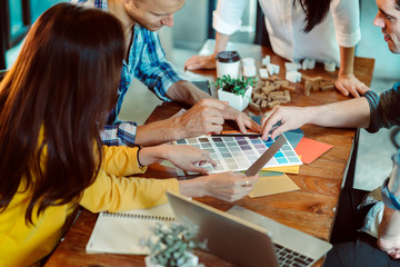 Fototapeta premium creative business meeting with caucasian and asian co worker discuss with paper laptop and happiness and joyful cafe background