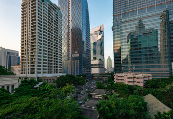 Obraz premium Tranquility inside the city. Image of green zone and modern buildings (Bangkok, Thailand)
