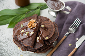 Fototapeta na wymiar Chocolate pancakes for Breakfast with hot chocolate.Selective focus.