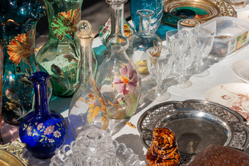 Antique glasses and plates for sale at a provencal flea market