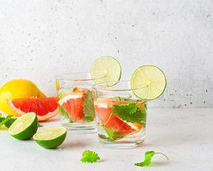 Glass of cool infused water with fresh grapefruit, lime and mint, (lemonade, cocktail). Detox drink, health care, fitness, diet concept.