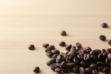 roasted coffee beans on a natural wooden table. Frame of coffee beans Robusta, Arabica. top view. space for text