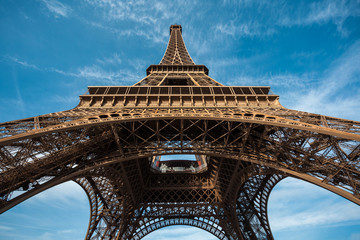 Wide shot of Eiffel Tower with blue sky, Paris, France.