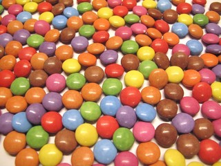 Fototapeta na wymiar Colourful colorful candies sweets chocolates buttons Smarties Skittles M&M’s