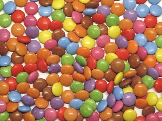 Fototapeta na wymiar Colourful colorful candies sweets chocolates buttons Smarties Skittles M&M’s