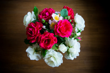 bouquet of beautiful red and white roses on a wooden