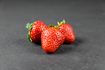fresh strawberries on gray background