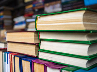 A large number of old books stacked on top of each other. Books for the study of different literature