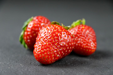 fresh strawberries on gray background