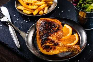 Grilled chicken leg with french fries and vegetables
