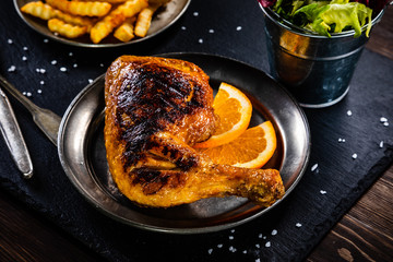 Grilled chicken leg with french fries and vegetables