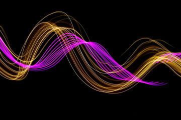 Long exposure photograph of neon purple and metallic gold colour in an abstract swirl pattern against a black background. Light painting photography.