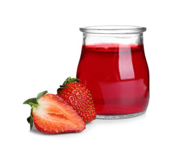 Strawberries and tasty jelly dessert in glass jar on white background