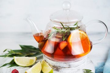 Summer tea in a kettle of fresh fruit and berries. Natural berry tea light background.