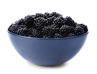 Blue bowl of tasty ripe blackberries on white background