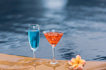 Glass of wine at swimming pool on vacation.