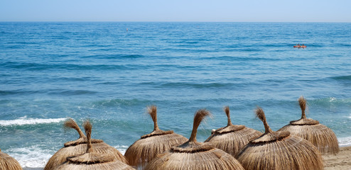 straw umbrella on the seashore